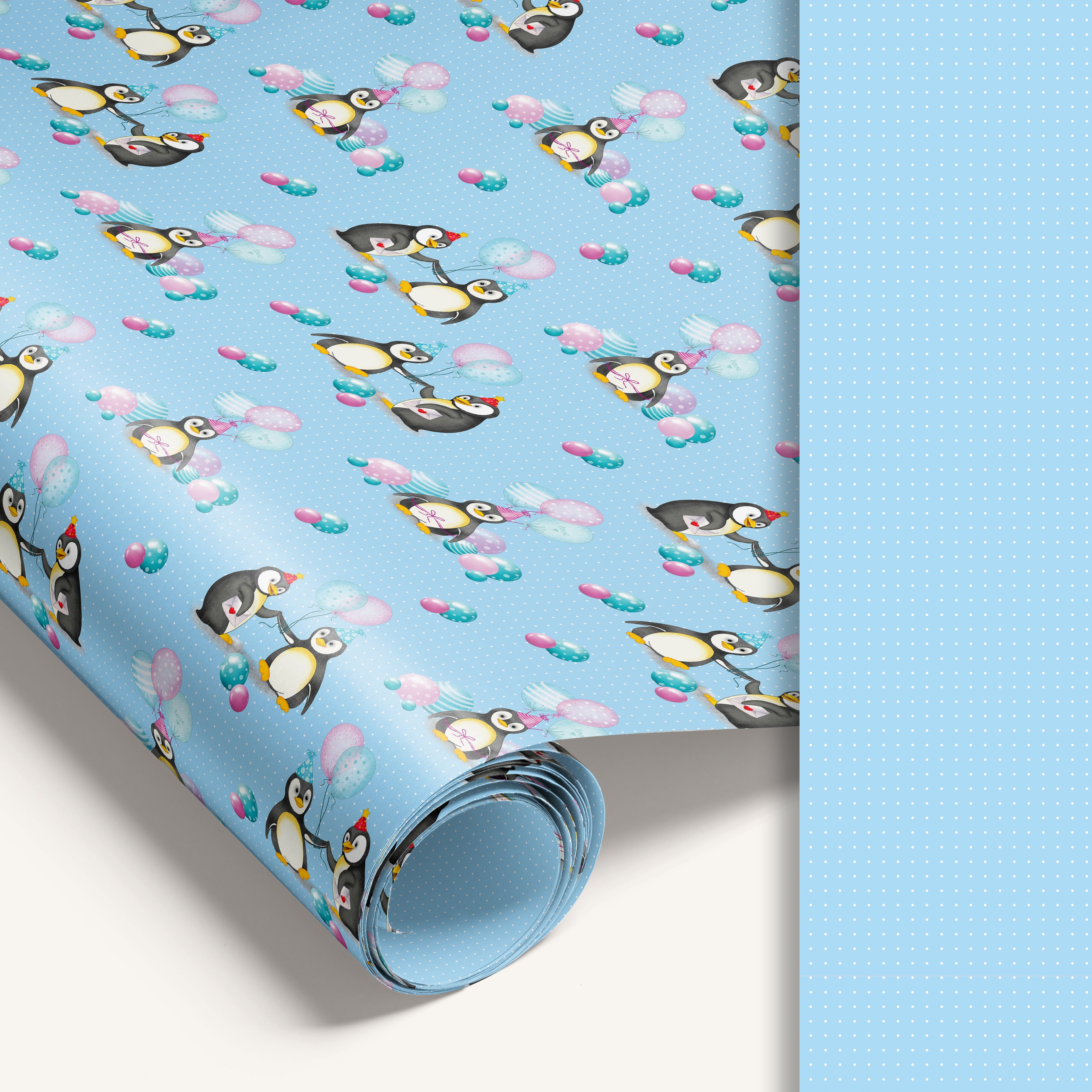 Blue penguin wrapping paper roll with blue dotted reverse side for easy cutting.