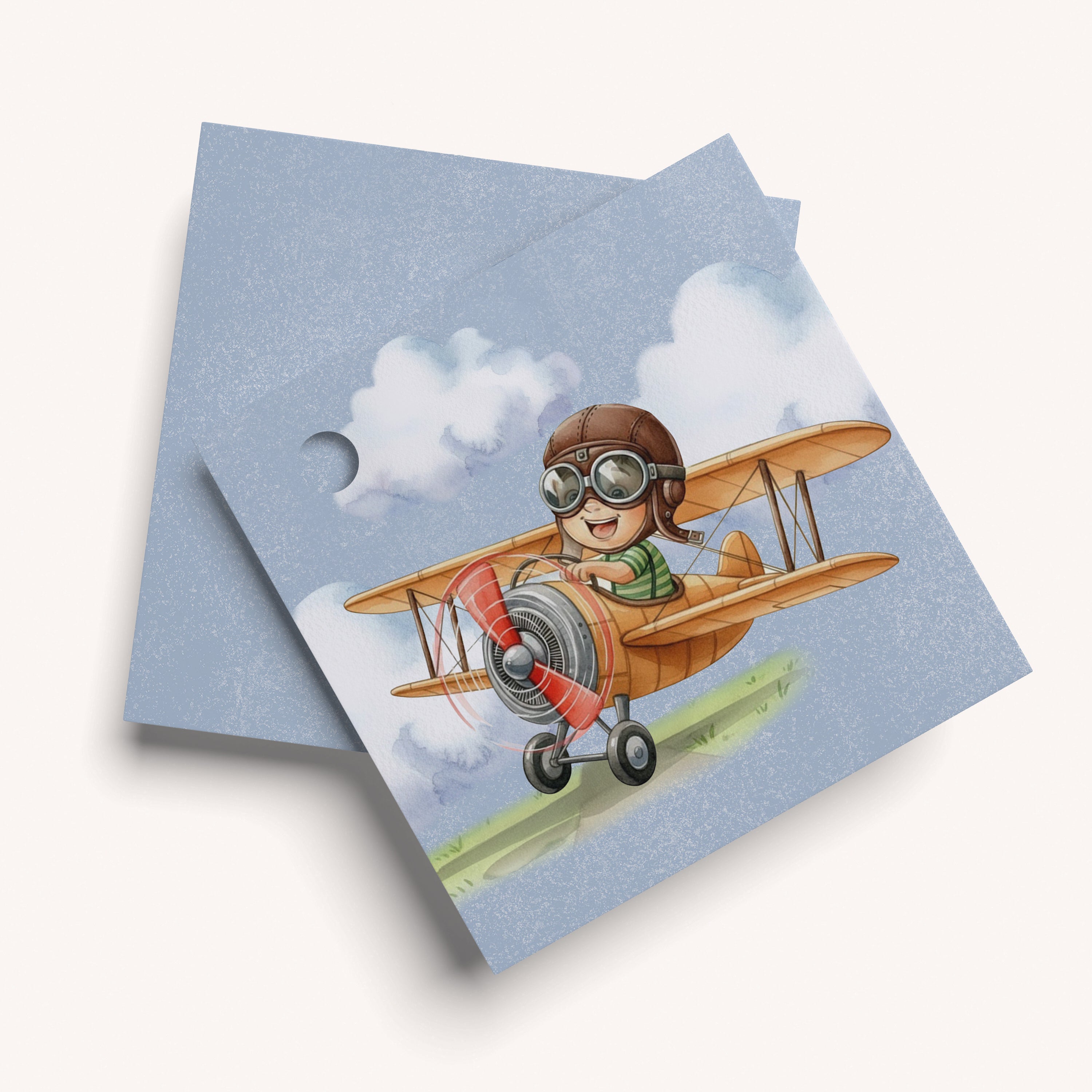 Name card with a design of a child in an airplane on a blue background
