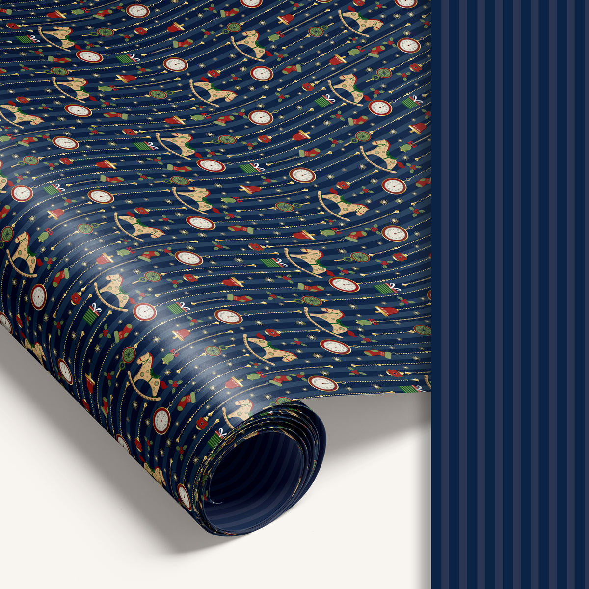 “Midnight Carousel” double-sided holiday wrapping paper featuring illustrated rocking horses and ornaments on one side and blue stripe design on the reverse.