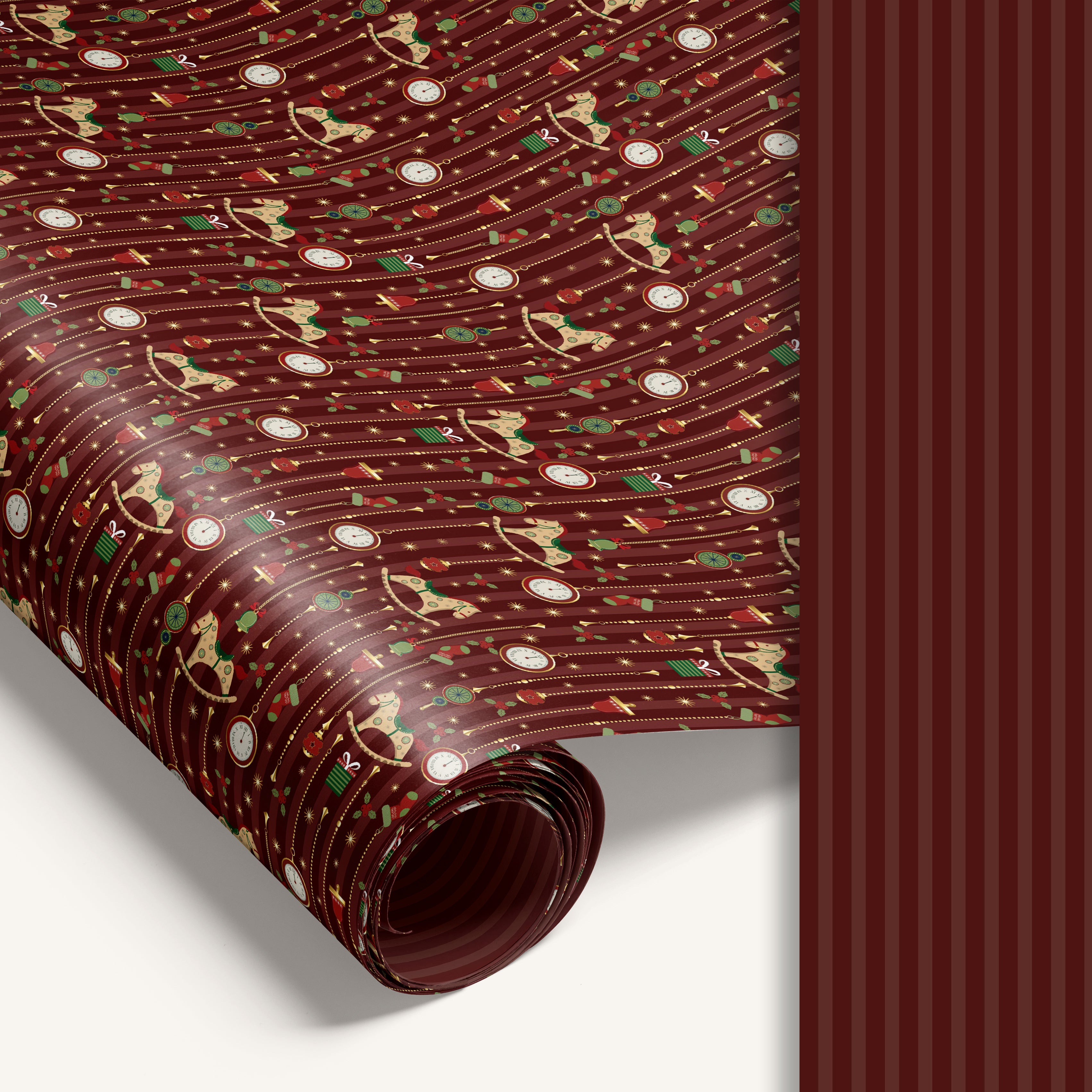 “Midnight Carousel” double-sided holiday wrapping paper featuring illustrated rocking horses and ornaments on one side and red stripe design on the reverse.