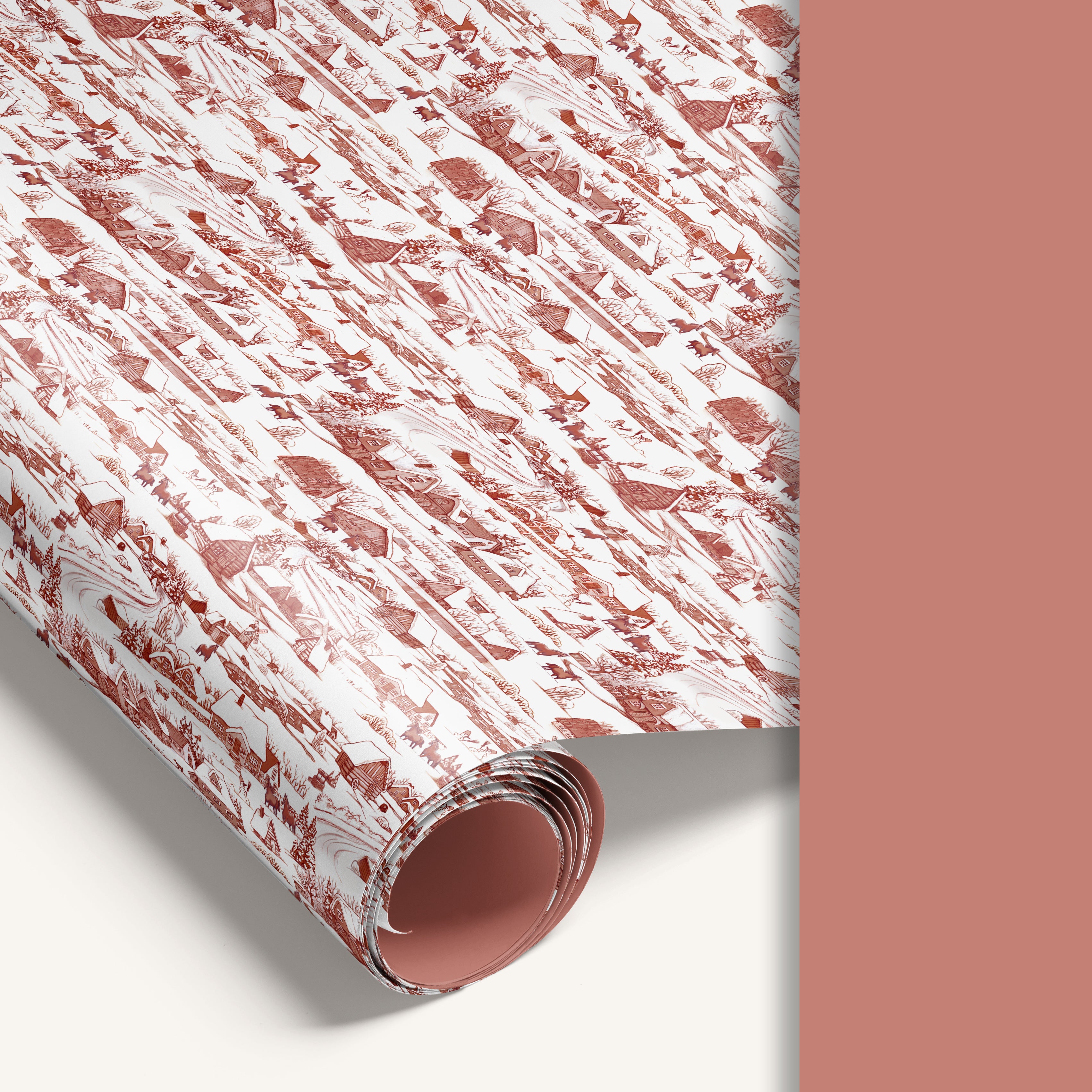 Winter Village double-sided wrapping paper featuring vintage snowy countryside illustration on one side and solid vintage soft red reverse.