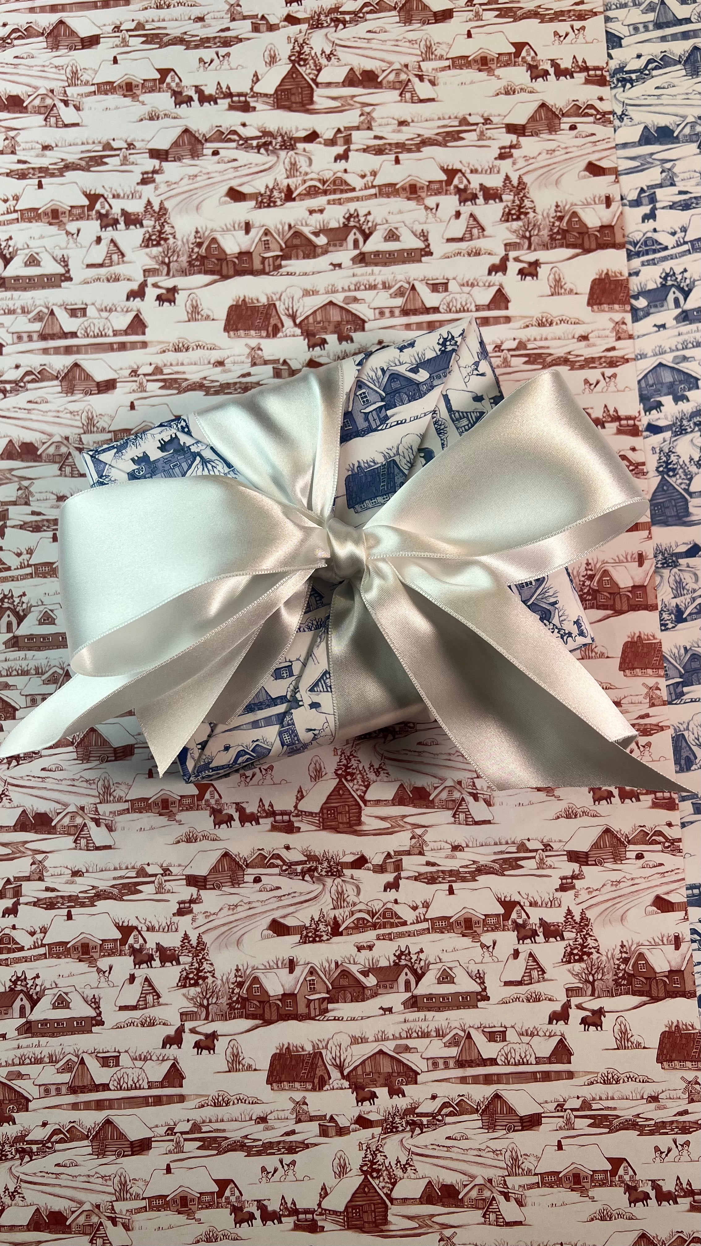 Small present wrapped in festive holiday wrapping paper.