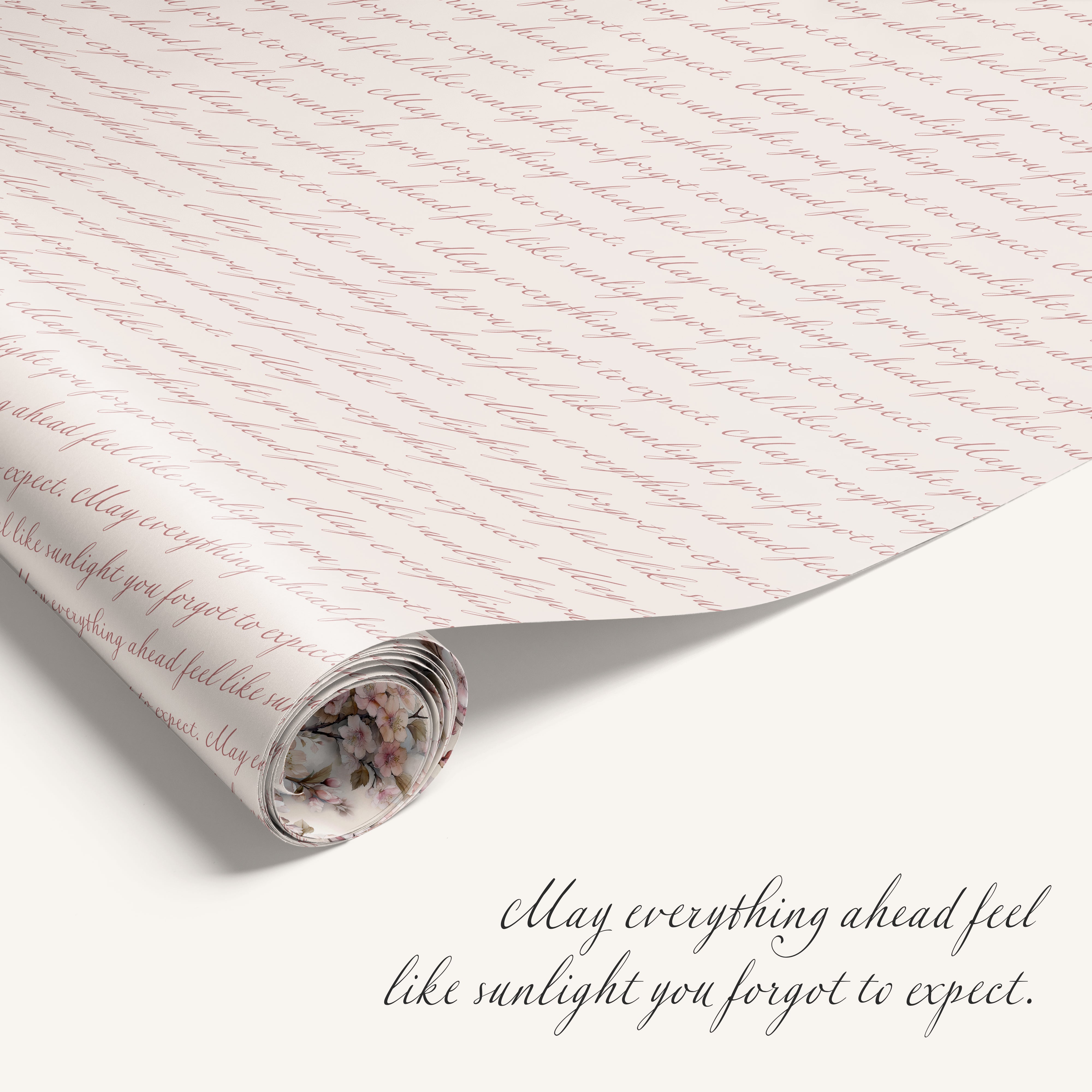 Roll of decorative paper with text and a small floral design, featuring an inspirational quote.