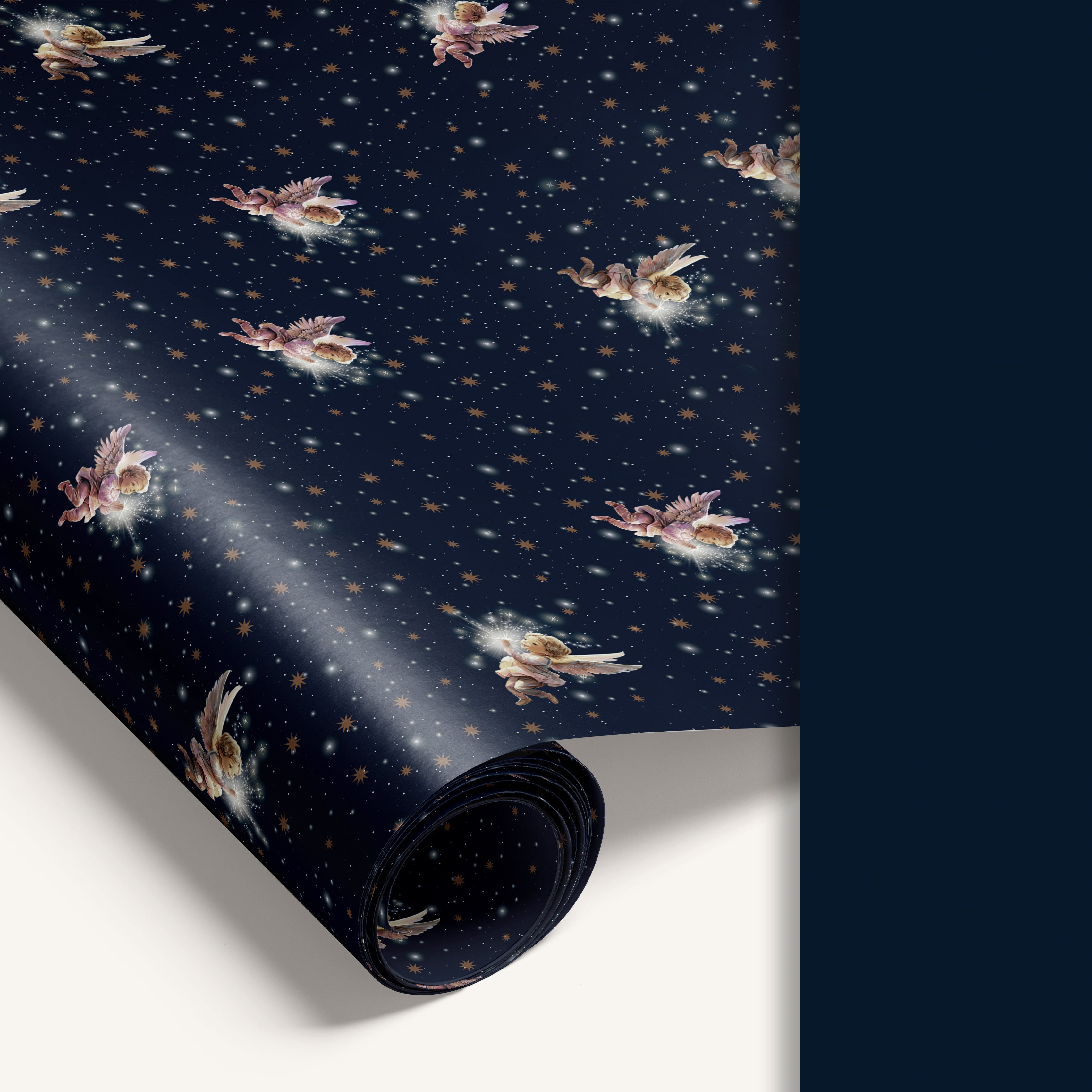“Angel’s Waltz” double-sided holiday wrapping paper featuring angel illustrations on one side and solid navy reverse.