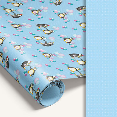 Blue penguin wrapping paper roll with blue dotted reverse side for easy cutting.