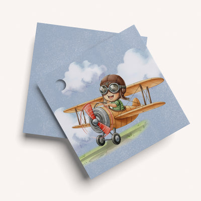 Name card with a design of a child in an airplane on a blue background
