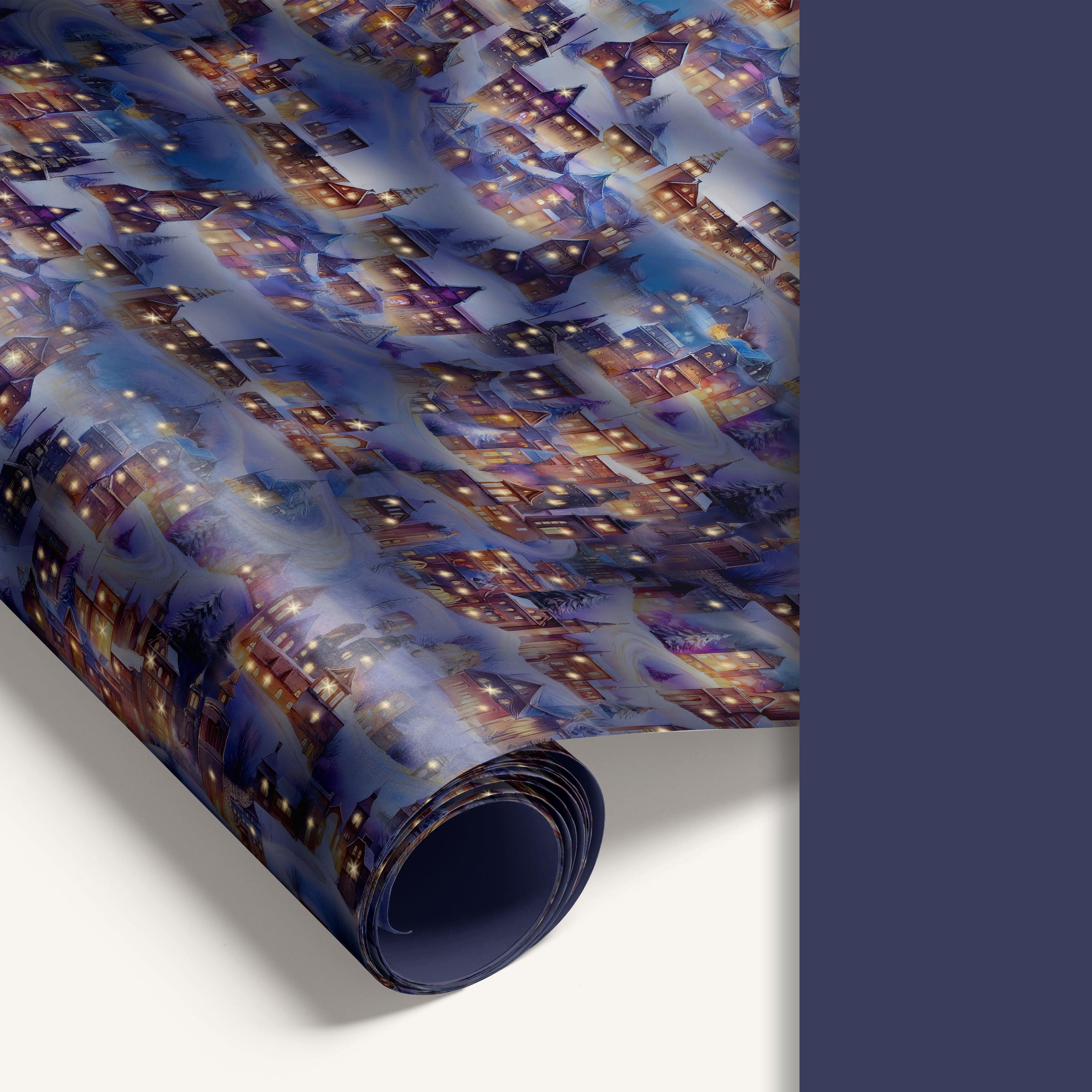 Double-sided winter village wrapping paper featuring a twilight village illustration on one side and a solid pastel blue reverse.