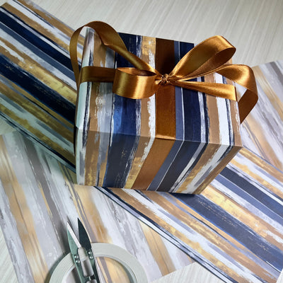 Gift Wrapped in Modern Tux Wrapping Paper featuring Navy blue Lines and Gold Ribbon