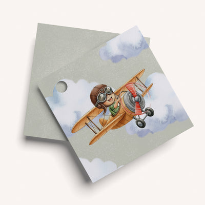 Name card with a cartoon character piloting an airplane in the green sky