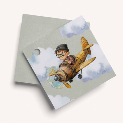 Name card with a cartoon boy on an airplane against a cloudy sky background
