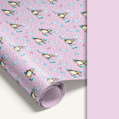 Pink penguin wrapping paper roll with solid pink reverse side.