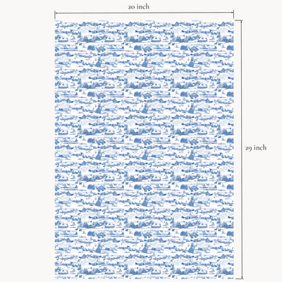 Winter Village wrapping paper sheet shown flat with printed measurements, featuring hand-illustrated snowy cottages and barns in red, blue, and coral color options.