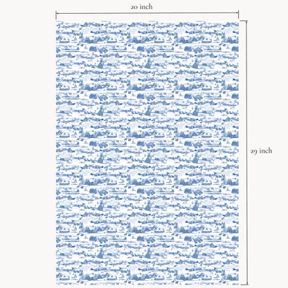 Winter Village wrapping paper sheet shown flat with printed measurements, featuring hand-illustrated snowy cottages and barns in red, blue, and coral color options.