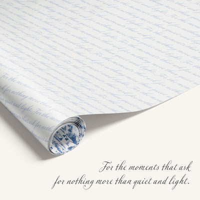 Winter Village double-sided wrapping paper featuring vintage snowy countryside illustration on one side and blue quite text on reverse.