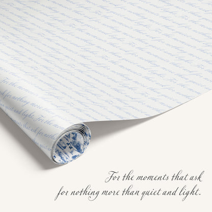 Winter Village double-sided wrapping paper featuring vintage snowy countryside illustration on one side and blue quite text on reverse.