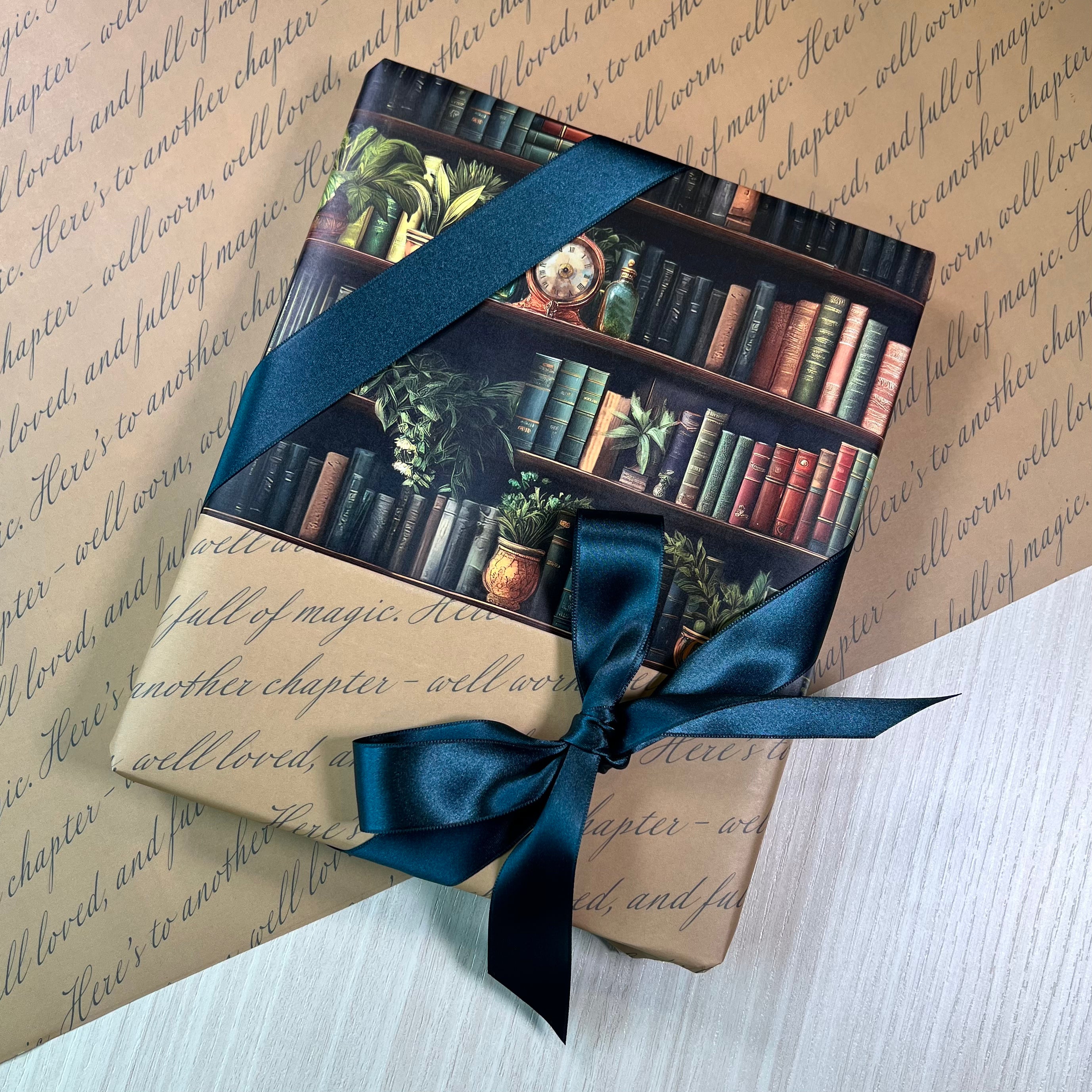 Gift wrapped in “Secret Library” double-sided wrapping paper featuring illustrated bookshelf design and tied with green ribbon.