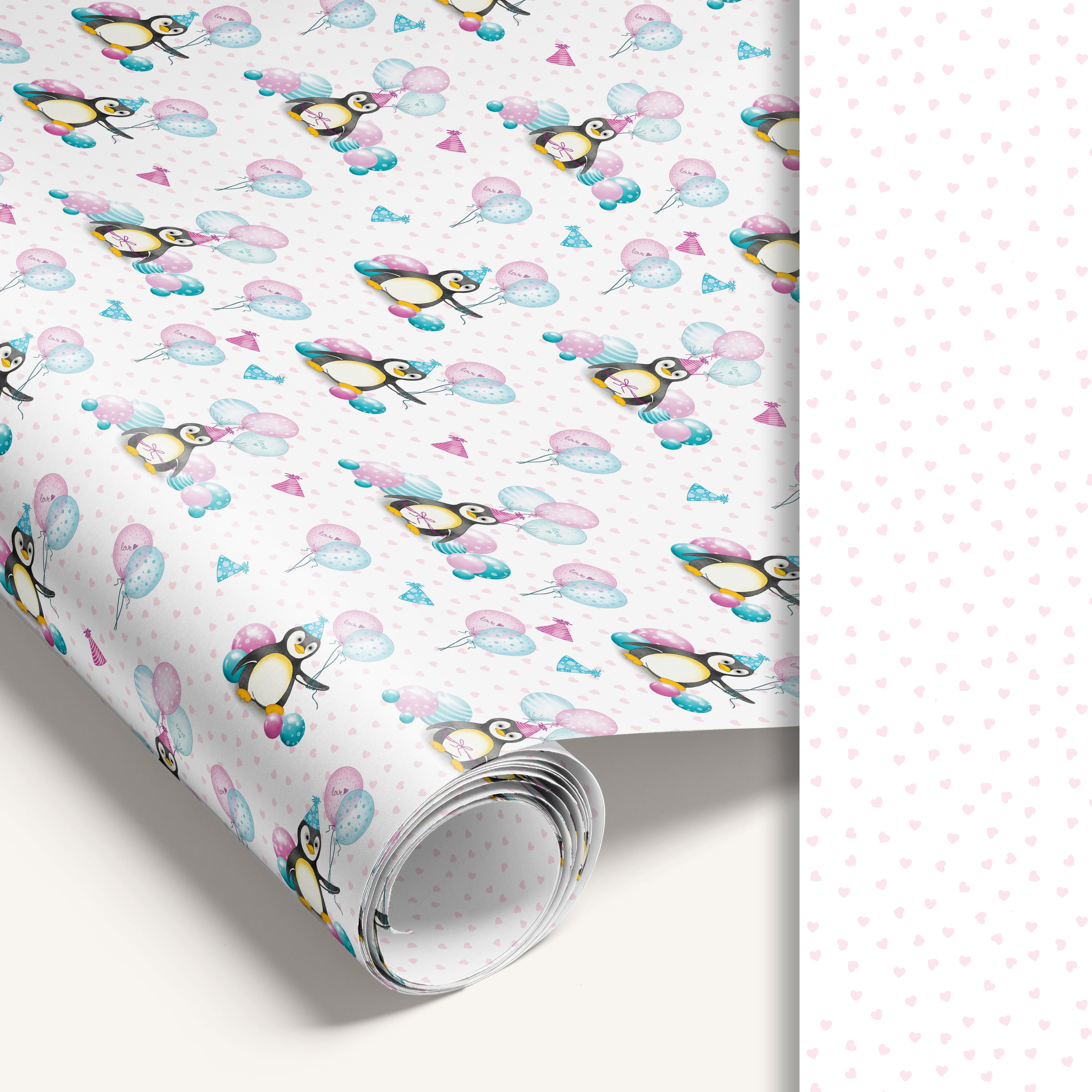 White penguin kids birthday wrapping paper roll with heart pattern reverse side.