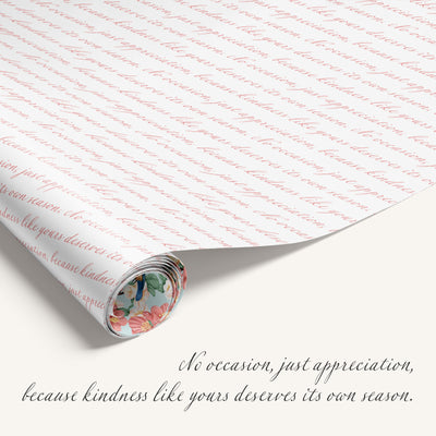Rolled-up gift wrap with cursive text and a floral label, featuring a quote about kindness.
