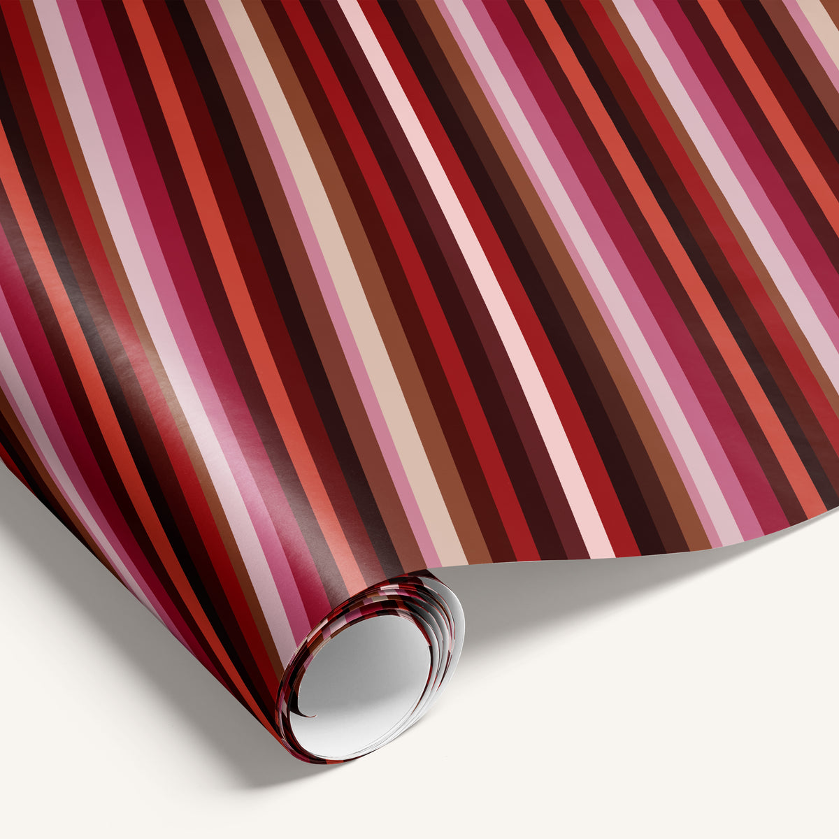 Roll of red and pink striped fabric on a white background