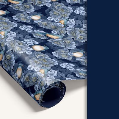 Roll of floral-patterned paper with blue and white flowers on a dark blue background