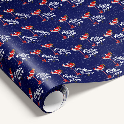 Roll of wrapping paper with Santa Claus design on a blue background