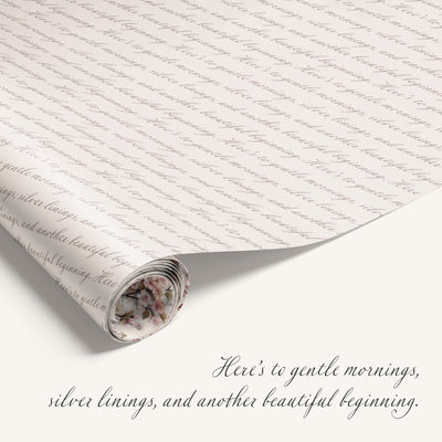 Roll of paper with cursive text and a floral design at the bottom, with a quote about gentle mornings and silver linings.